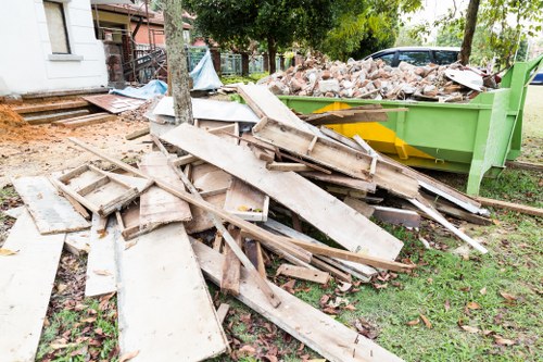 A skip being loaded with building debris